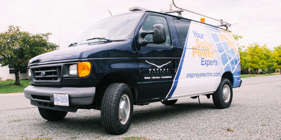 A blue and white van branded with "Osprey Electric" and "Your Solar Power Experts" parked on a street, equipped with a ladder on top.