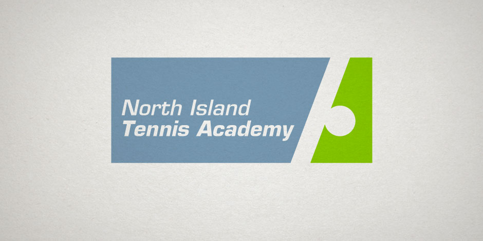 Logo of North Island Tennis Academy with white text on a blue rectangular background and a green section featuring a white circle on the right.