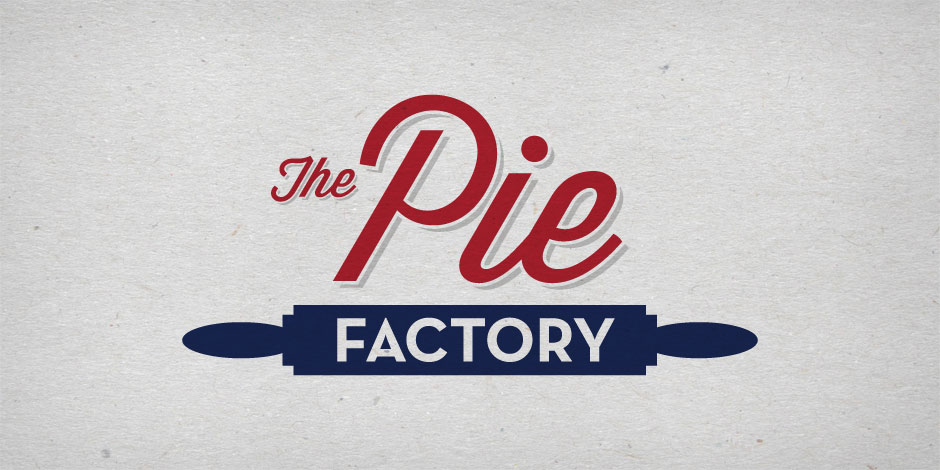 Logo of "The Pie Factory" with "The Pie" in red script and "FACTORY" in white block letters on a navy blue banner, against a light gray textured background.