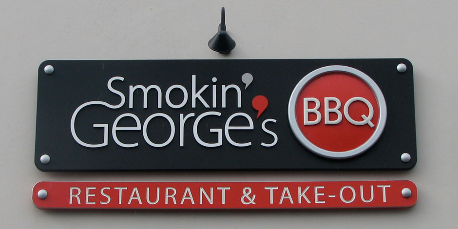 Sign for "Smokin' George's BBQ" with a smaller sign below that reads "Restaurant & Take-Out".